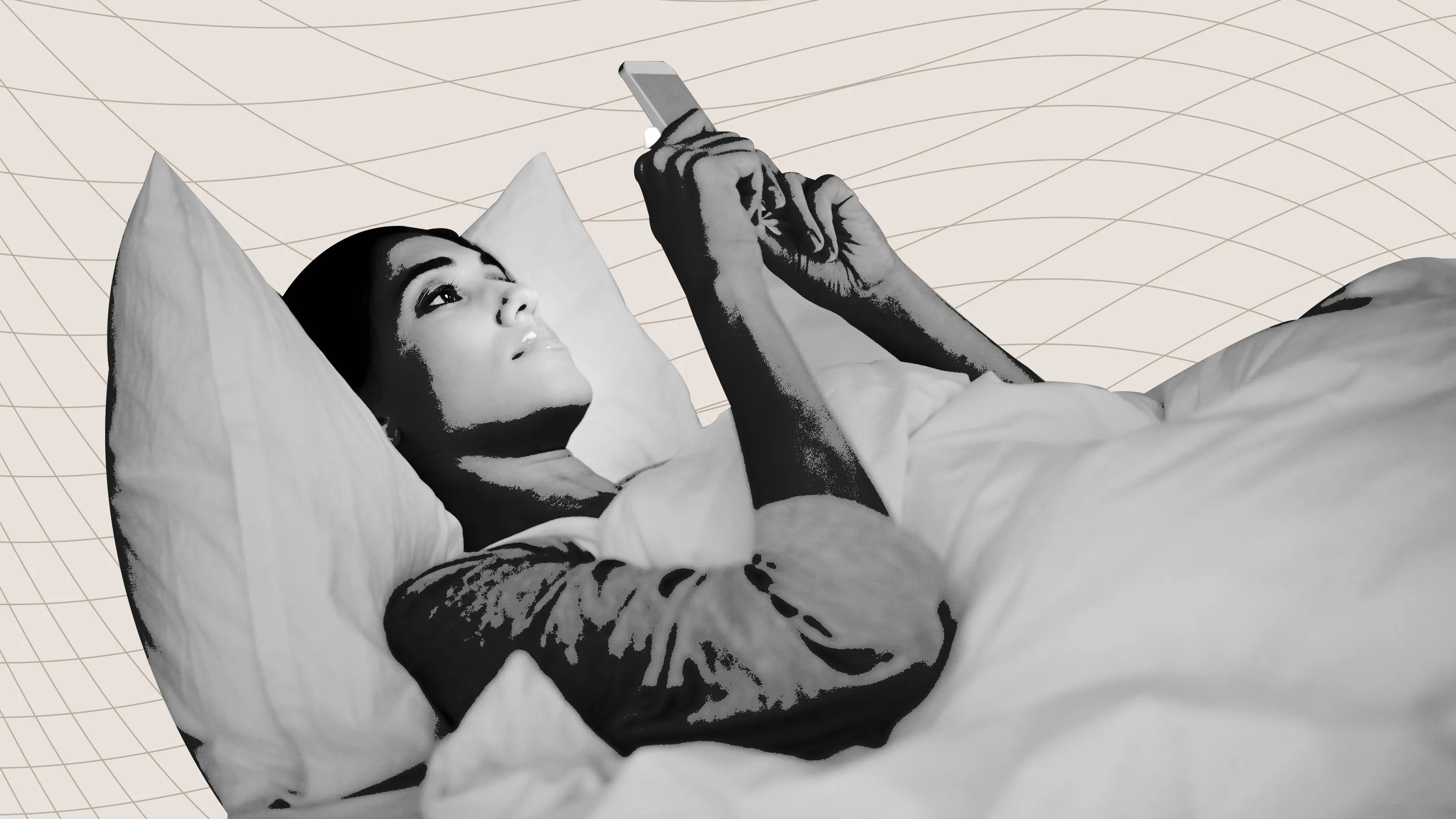 Woman with her phone in bed